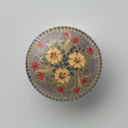Round wooden brooch with floral decoration