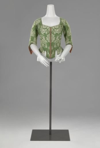 Bodice or stays of silk with white flowers on grass-green ground, square neck, half-length sleeves with 'manches à racquette', front panels with boning and busk, linen lining