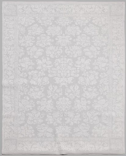 Napkin with scattered flower sprigs and monogram in the corners