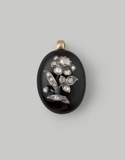 Gold pendant/brooch set with diamond flower appliqué on onyx