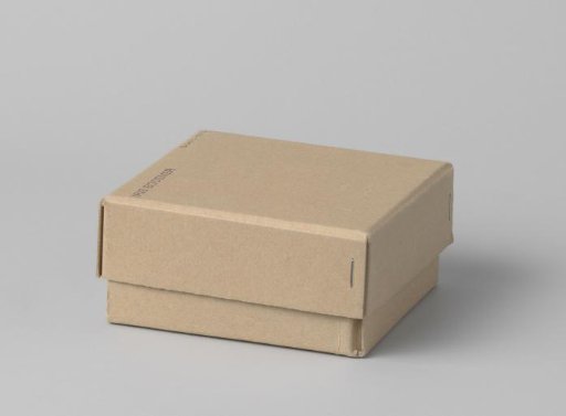 Box of cardboard with loose lid and grey foam rubber