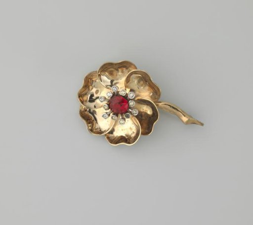 Brooch of metal and glass