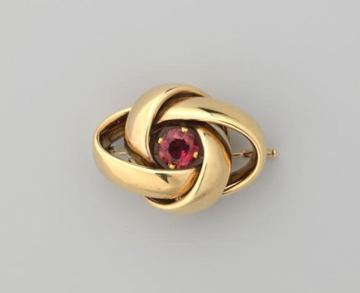 Braided gold brooch with pink tourmaline