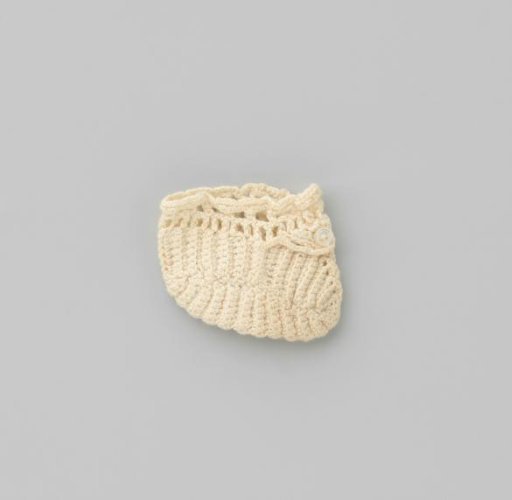 White crocheted sock with pearl-coloured button