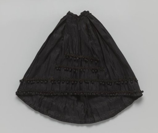 Black skirt with two rows of hanging balls along the lower edge