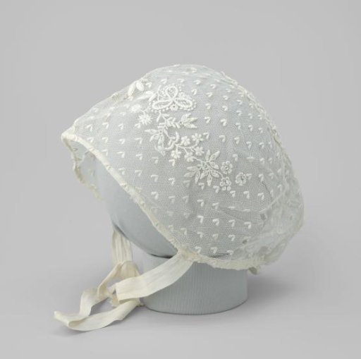 Baby bonnet of white tulle with white embroidery and two bows