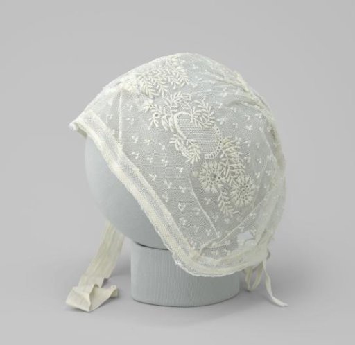Baby cap of white tulle with white embroidery and two bows