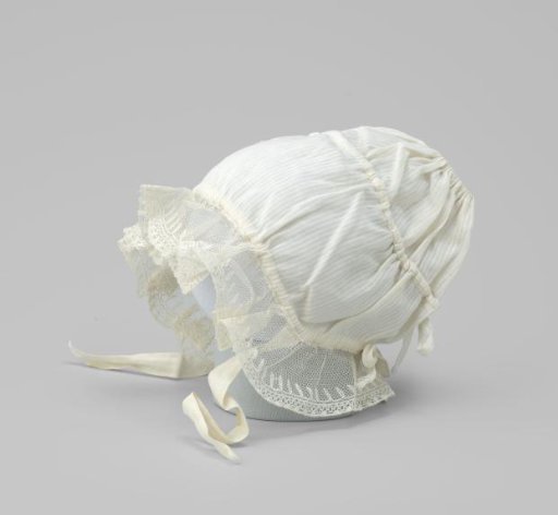 Baby cap of white textile with woven stripe with gathered applied strip of tulle with tulle stuffing work