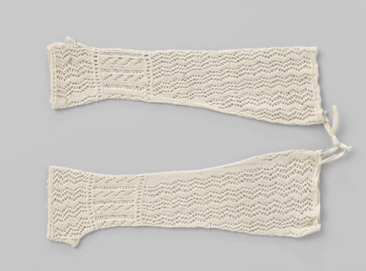 Openwork knitted baby mittens of white cotton