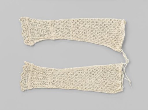 Openwork knitted baby sleeve of white cotton