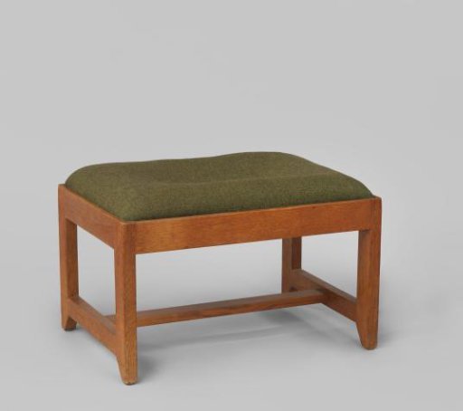 Footstool upholstered in green wool