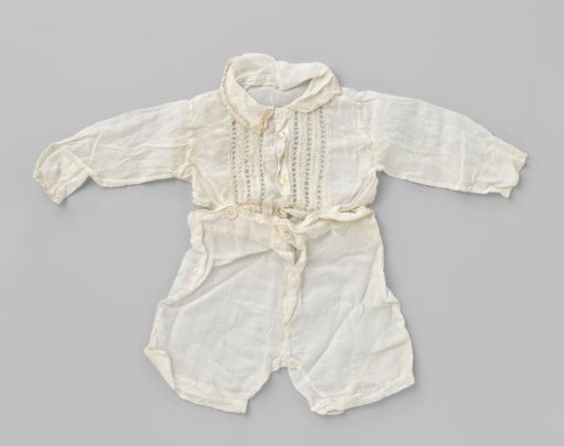 White suit with a long-sleeved upper part fastened to short trousers