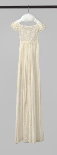 White baptismal gown with white embroidery and ruffles on the sleeves