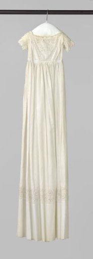 White baptismal gown with white embroidery and a straight wide hem