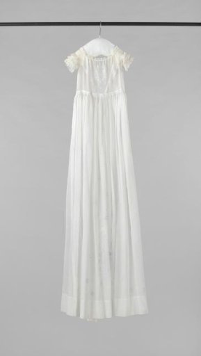 White baptismal gown with white embroidery and a straight wide hem