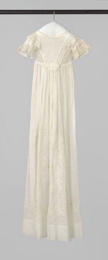 White baptismal gown with white embroidery, a straight wide hem, and a strip of Valenciennes lace around the neck