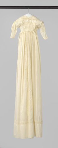 White baptismal gown with white embroidery and a straight wide hem