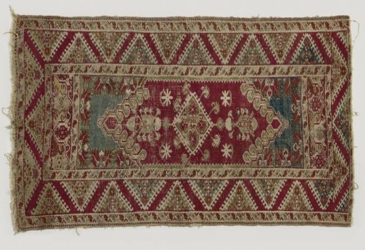 Woolen carpet decorated with stylized branches and flowers
