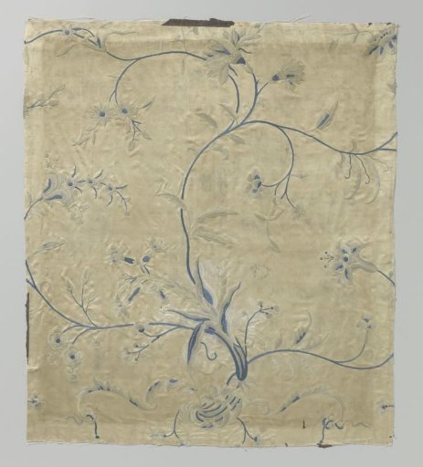 Fragment of satin with a blue embroidered branch
