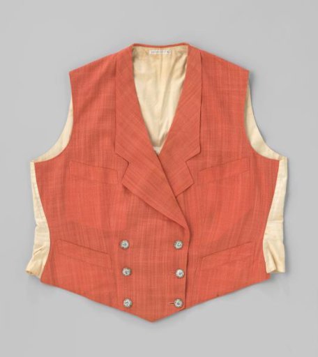 Jacket with four pockets, 6 white buttons with flowers and lapels of orange linen (?); the back with belt and buckle is of white cotton.