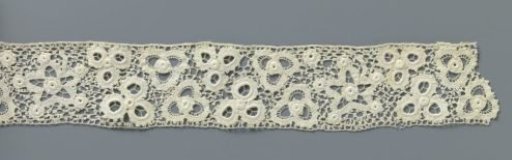Strip of crocheted lace with five-pointed stars and flowers made with open circles