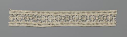 Strip of needle lace with small dense and large open circles