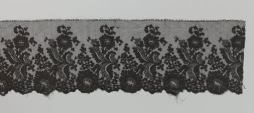 Strip of machine-made lace with a large hanging flower