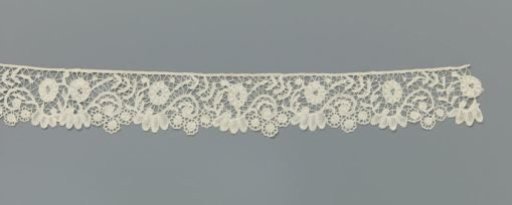 Strip of bobbin lace with S-scrolls