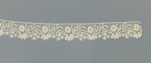 Strip of bobbin lace with S-scrolls