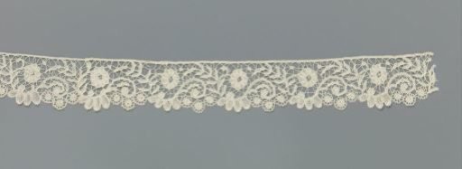 Strip of bobbin lace with S-scrolls