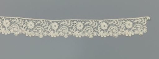 Strip of bobbin lace with S-scrolls
