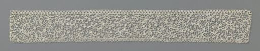 Strip of needle lace with sparse spiral vines