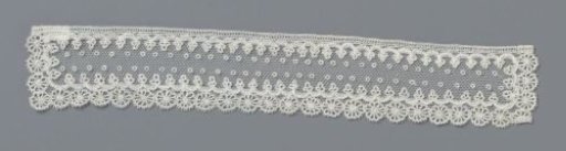 Cuff of applied lace with chain of miniature rosettes
