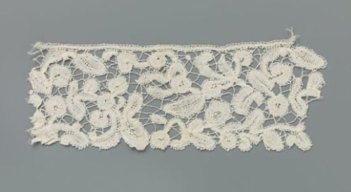 Strip of bobbin lace with simple flowers and leaves