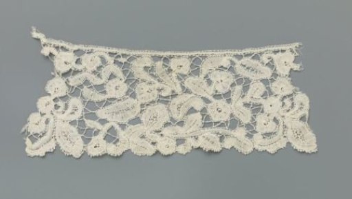 Strip of bobbin lace with simple flowers and leaves