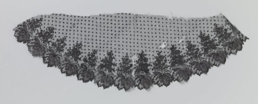 Half-oval fragment of bobbin lace with sprinkling pattern and leaf border