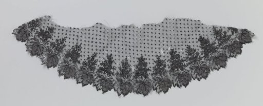 Half-oval fragment of bobbin lace with a sprinkling pattern and leaf border
