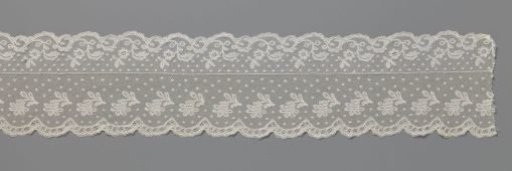 Strip of bobbin lace with curved branches