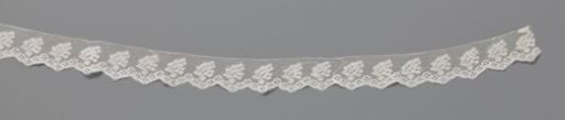 Strip of bobbin lace with flower clusters