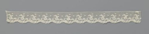 Strip of bobbin lace with rosette flower crowned by leaves
