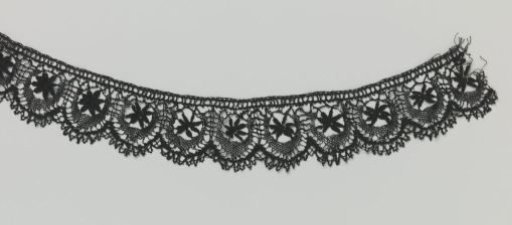Strip of bobbin lace with a star and crescent moon