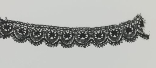 Strip of bobbin lace with star and half-moon