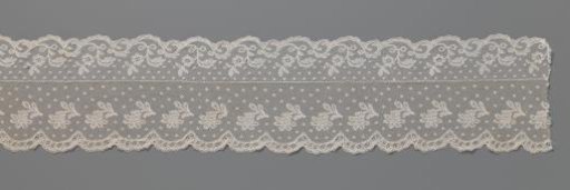 Strip of bobbin lace with S-shaped branch and rosette