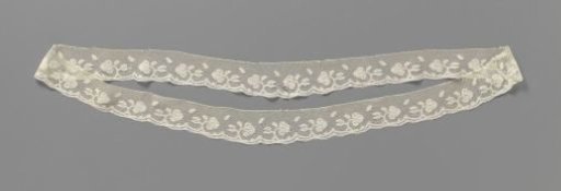 Strip of bobbin lace with flower and flower bud on a curved branch