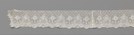Strip of bobbin lace with hexagonal medallions