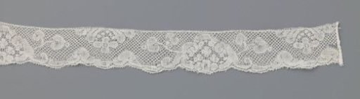 Strip of bobbin lace with triangular medallions