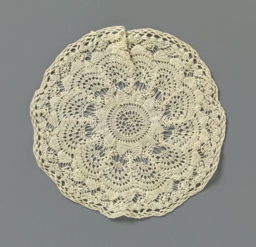 Round piece of knitted lace with concentric rosettes