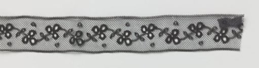 Insert of machine-made lace with wave scroll