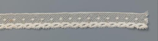 Strip of bobbin lace with twisted bands