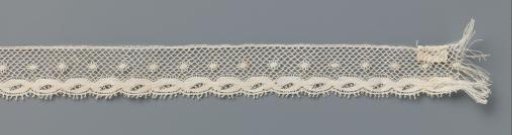 Strip of bobbin lace with twisted bands
